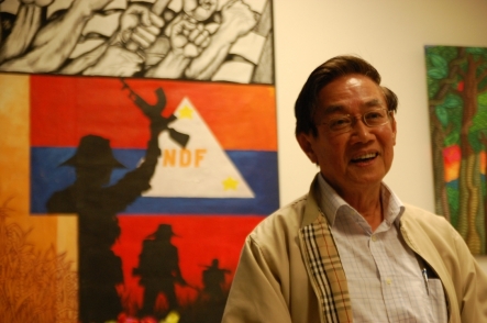 Luis Jalandoni in his office in Utrecht, Holland, in front of a NDF poster.