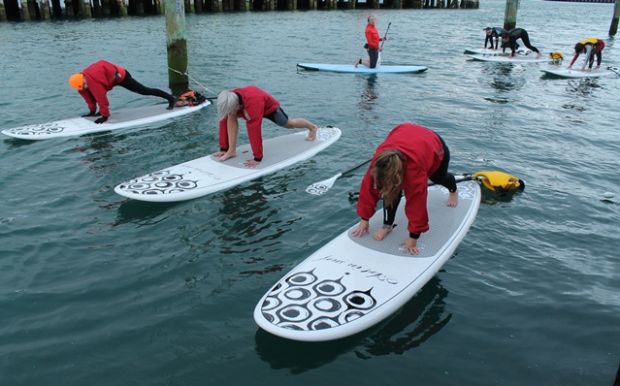 Yoga standing up on paddle boards